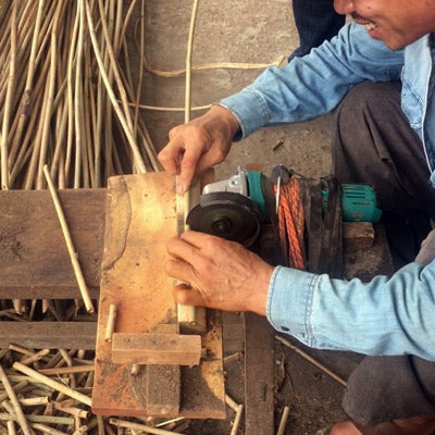 Bamboo straws being cut 
