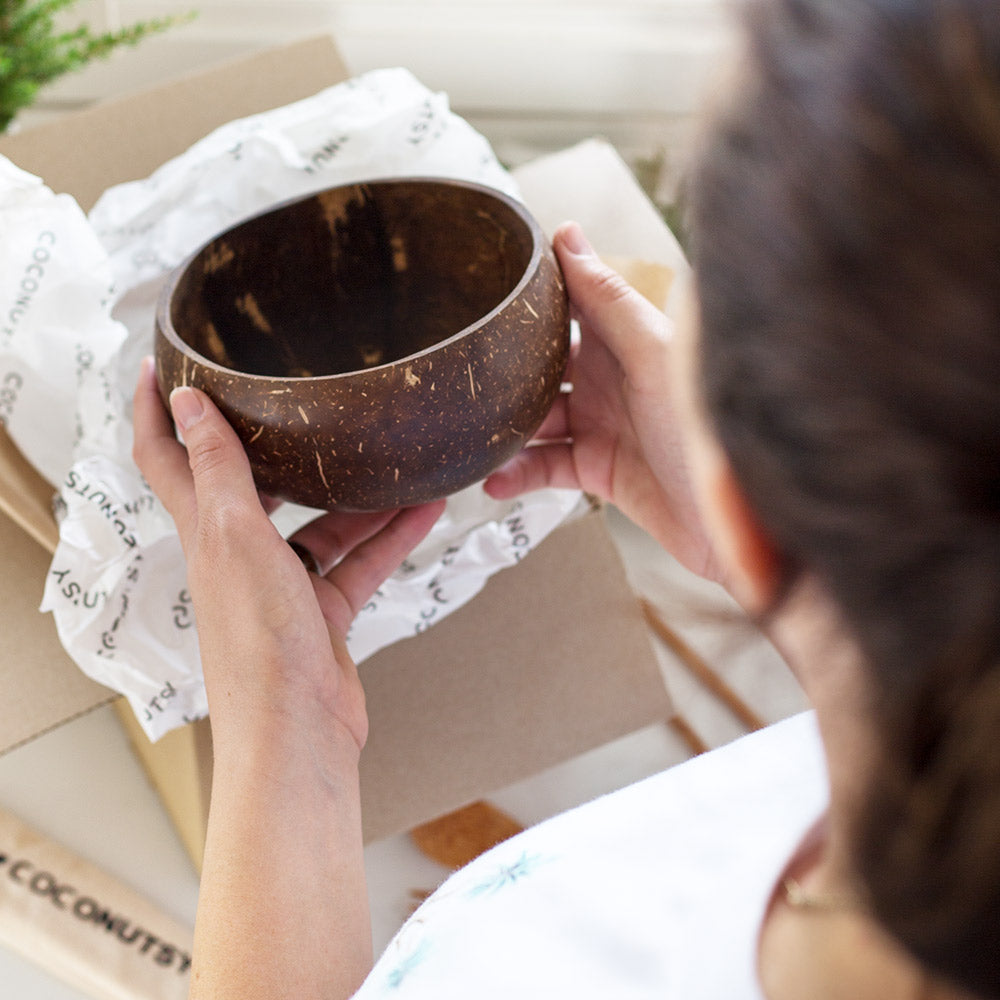 Unwrapping a coconut bowl gift