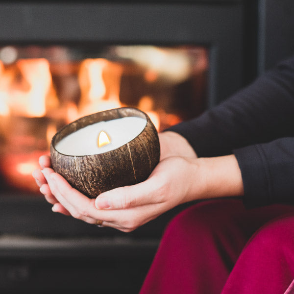Enjoying a coconut candle in front of a fireplace