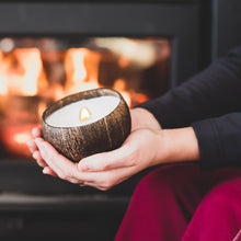 Load image into Gallery viewer, Enjoying a coconut candle in front of a fireplace
