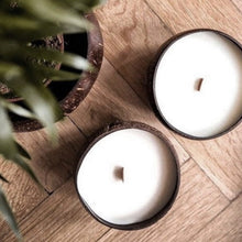 Load image into Gallery viewer, Coconut candles sitting on a table
